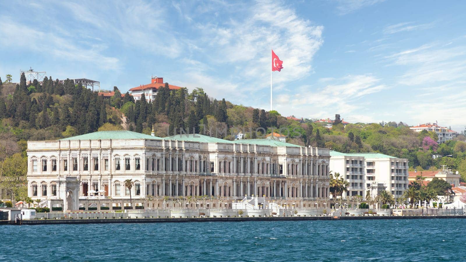 View from the Bosphorus strait of Ciragan Palace Kempinski, a luxury hotel located in Istanbul, Turkey. The palace was built in the 19th century and is now a popular tourist destination