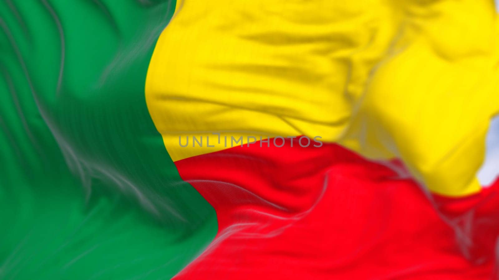 Close-up of Benin national flag waving. Two horizontal yellow and red bands on the fly side and a green vertical band at the hoist. 3d illustration render. Fluttering fabric. Selective focus