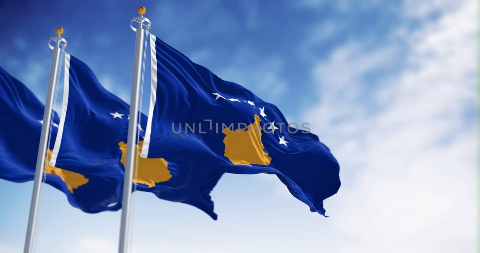 Three national flag of Kosovo waving in the wind on a clear day. Six white stars above a golden map of Kosovo in a blue field. 3d illustration render. Selective focus. Fluttering fabric