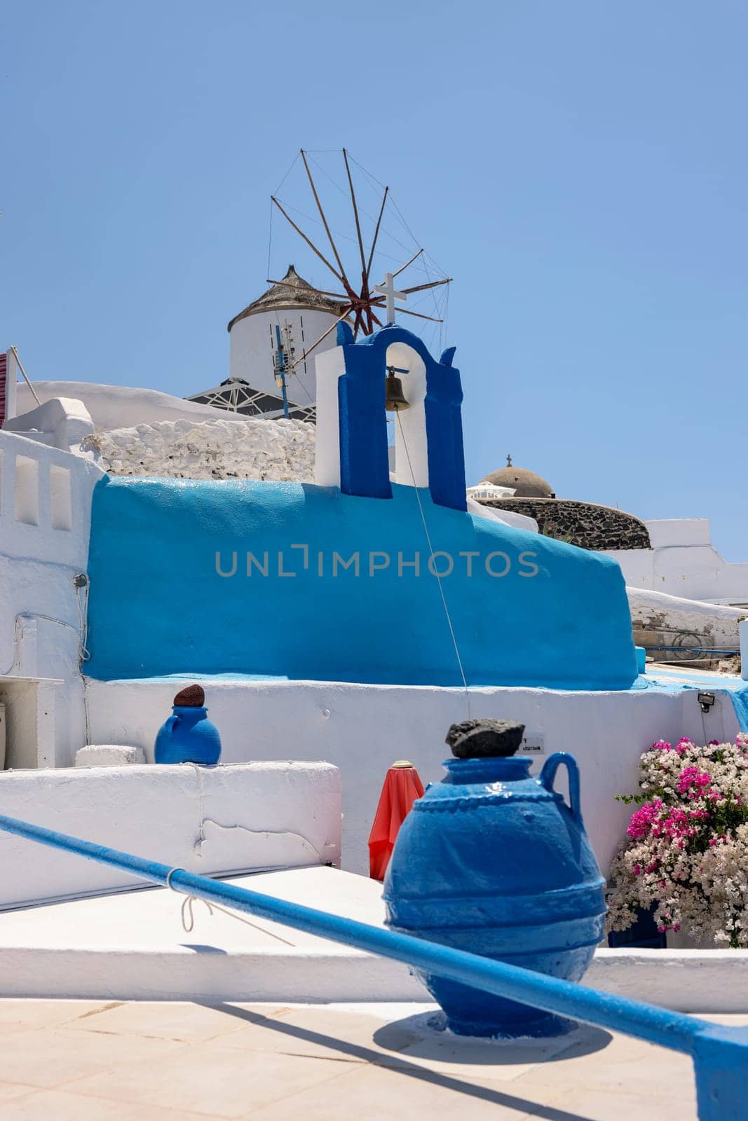Whitewashed houses and windmill in Oia on Santorini island, Cyclades, Greece