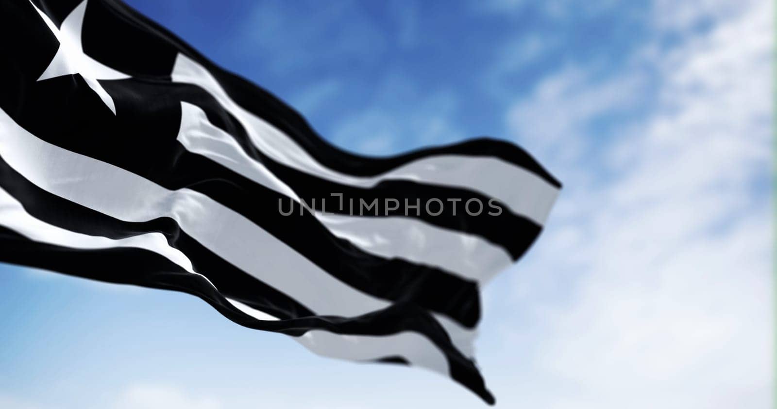 Flag of Botafogo football club waving in the wind on a clear day. Brazilian sports club, playing in the Brasileirao Serie A. Illustrative editorial 3d illustration render