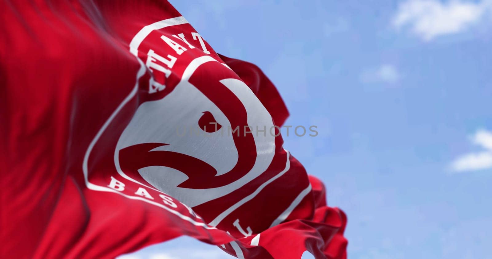 Flag of Atlanta Hawks waving in the wind on a clear day. American professional basketball team, member of the Eastern Conference Southeast Division. Illustrative editorial 3d illustration render