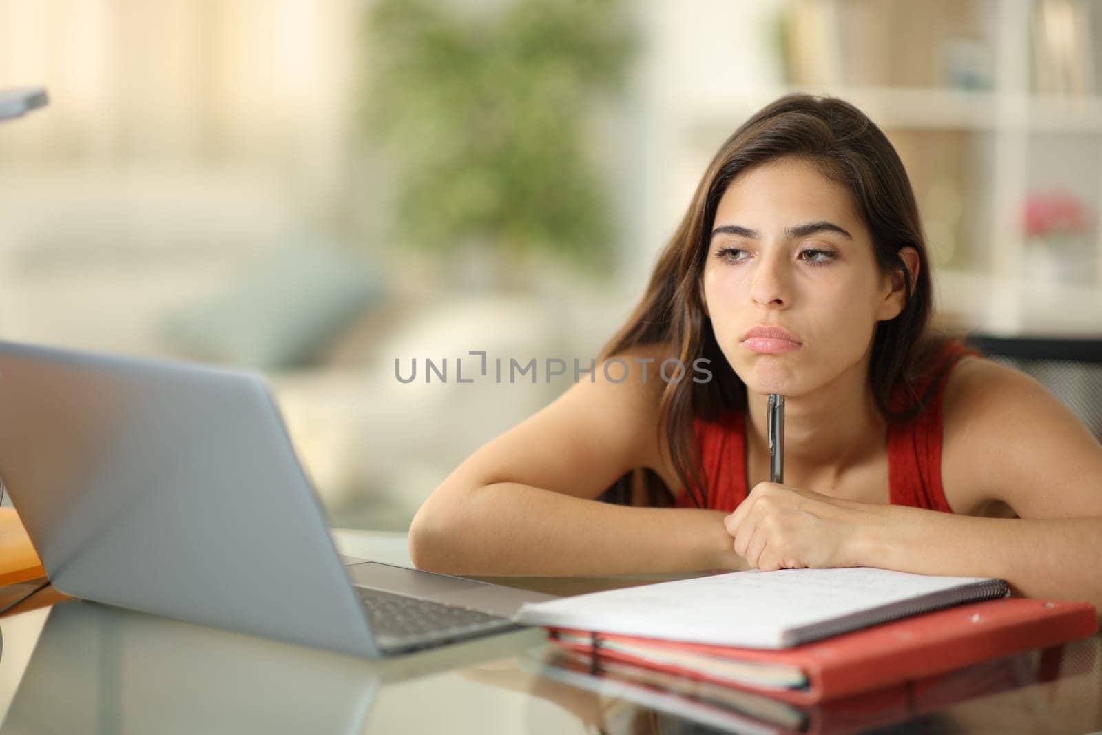 Bored student wasting time alone at home