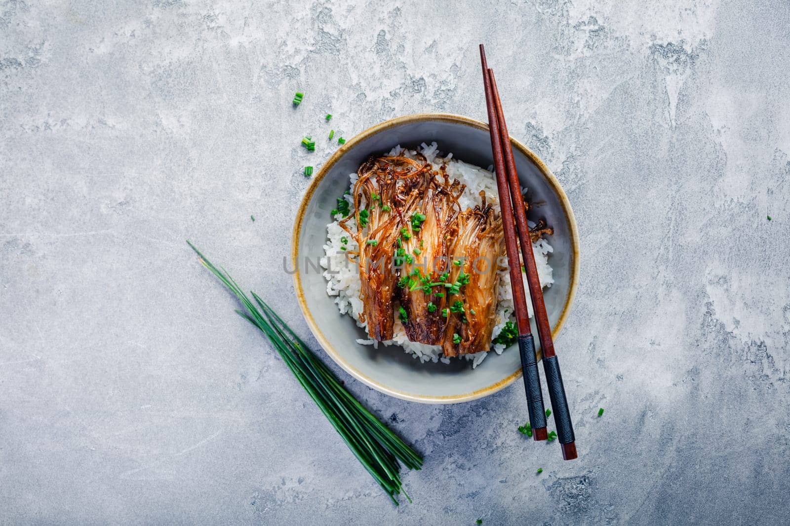 Rice with enoki mushrooms and chives. Asian vegan diet meal.