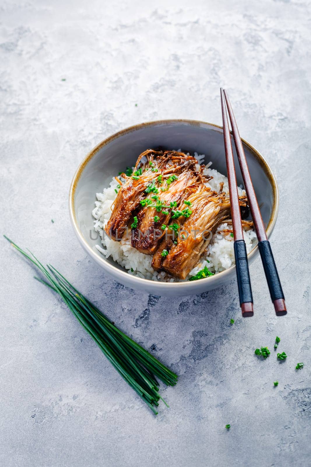 Rice with enoki mushrooms and chives. Asian vegan diet meal.