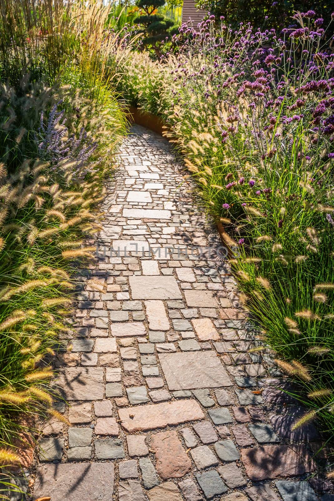 Modern pondless garden waterfall in a backyard with slate stones