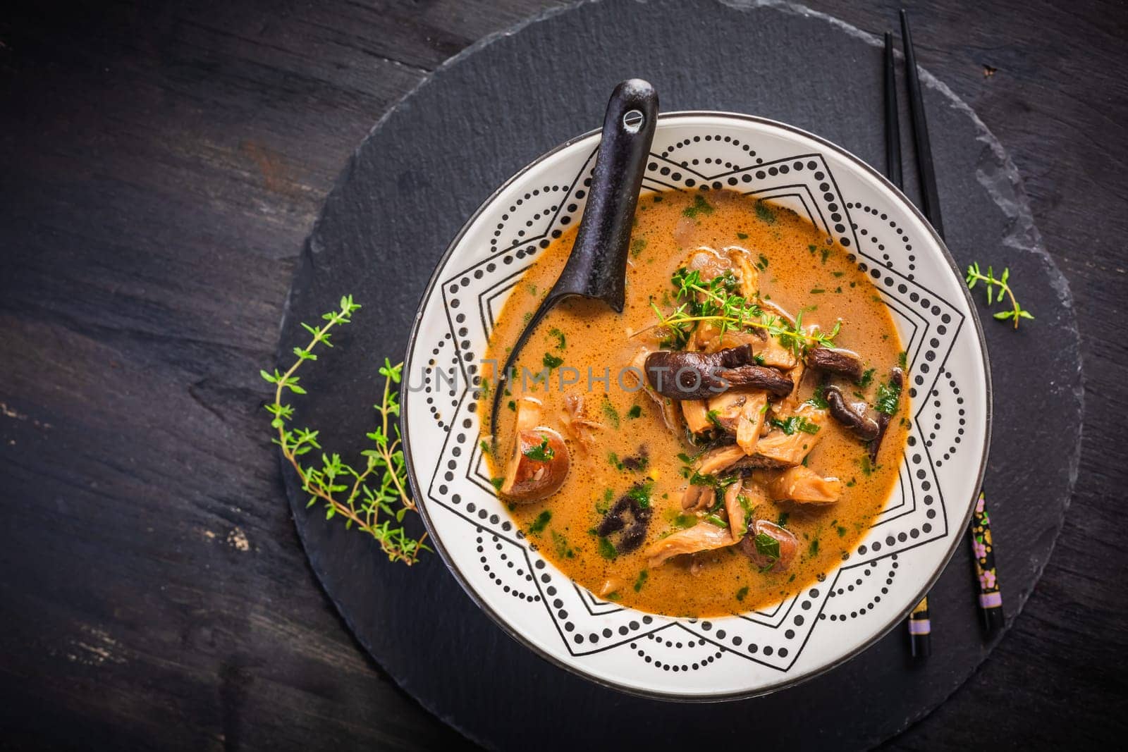 Homemade miso mushroom soup with coconut milk, with assorted edible mushrooms