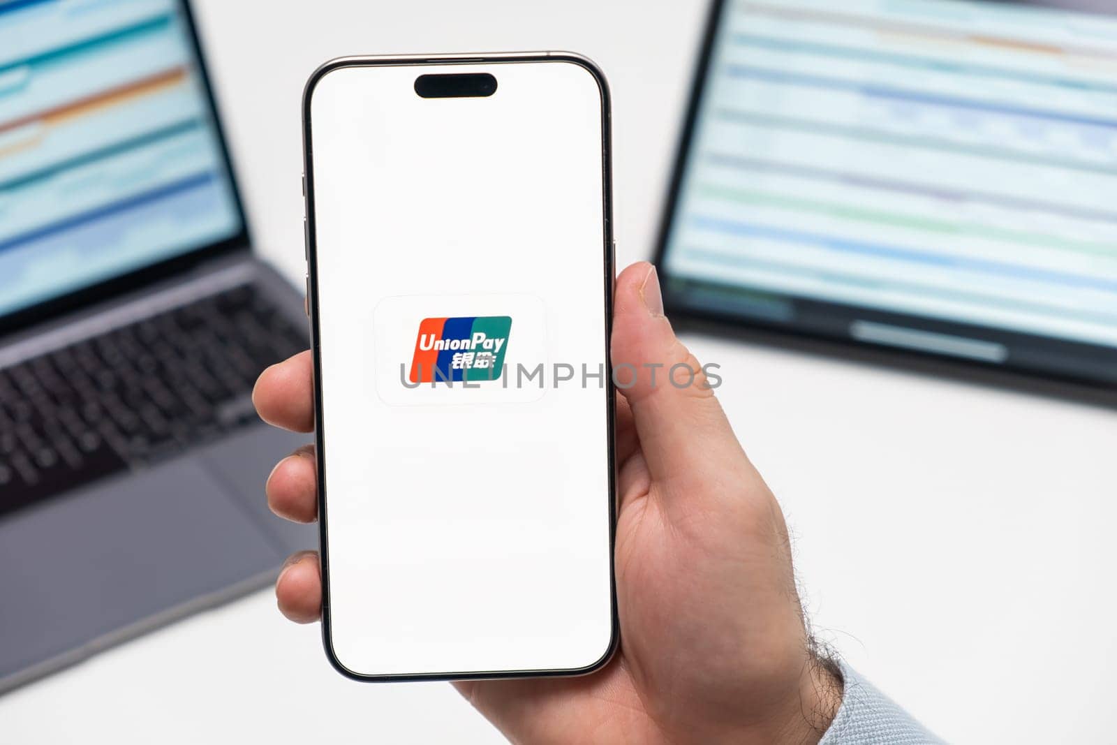 PRAGUE, CZECH REPUBLIC - JANUARY 21 2024: Union Pa logo on the screen of smartphone in mans hand on the workplace background.