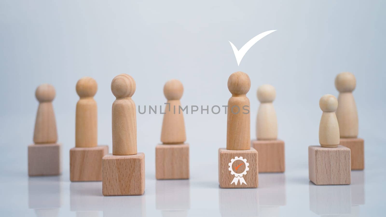 Concept Business and HR for leadership and team leader, one wooden dolls different and stand out from the group.