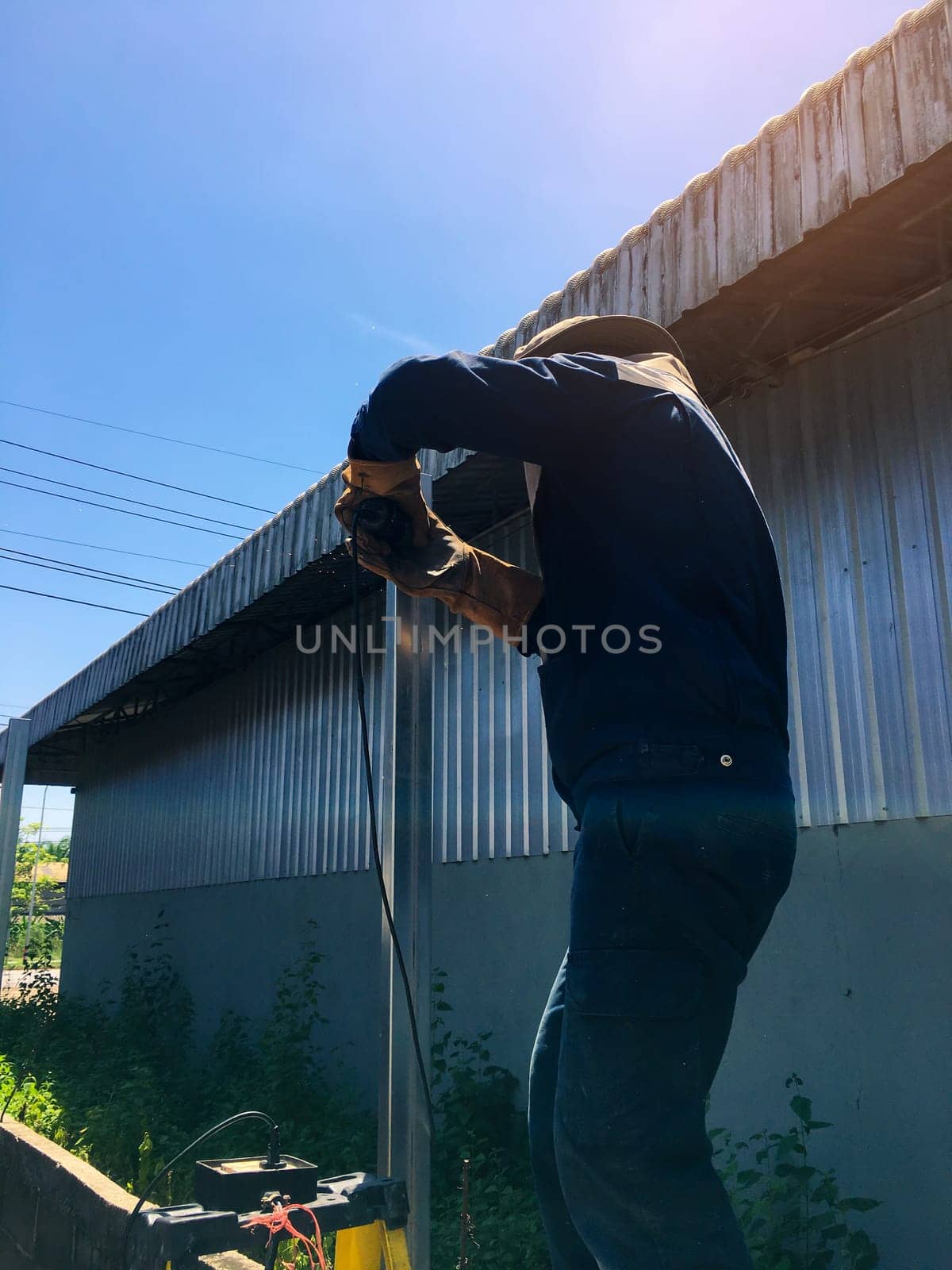 Cutting Metal, Man with cutting steel tool blurred background, Construction concept