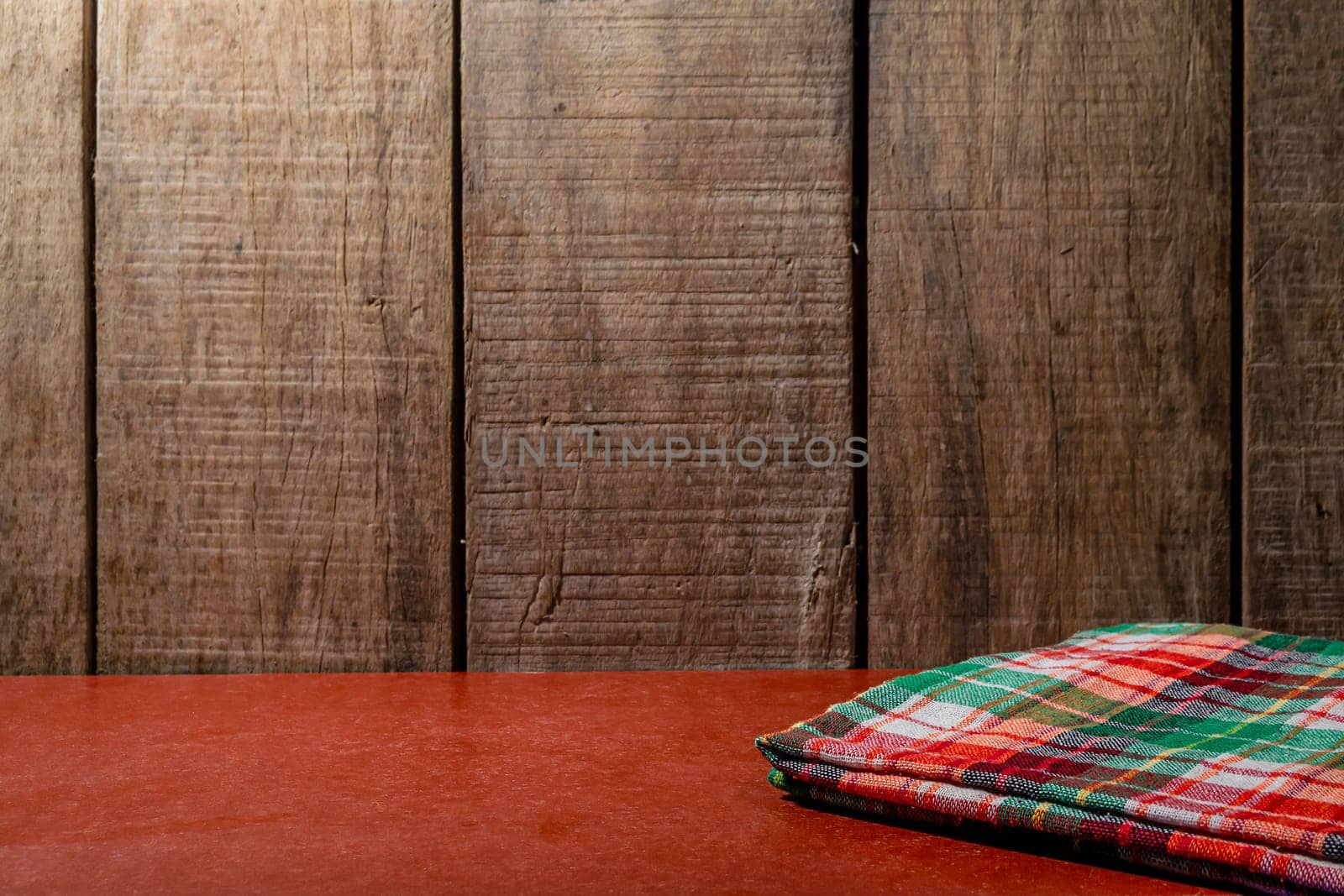 Empty wooden desk table and cloth, Old brown dark wood wall texture and pattern background for design, Still life style.