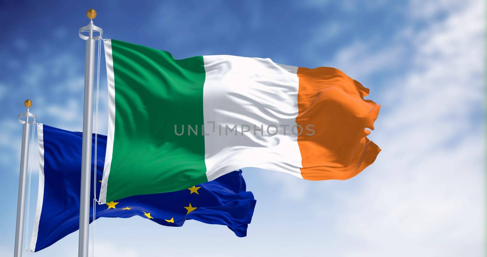 The flags of Ireland and the European Union fluttering together on a clear day. Ireland became a member of the European Union on 1973. 3d illustration render. International treaty and diplomacy