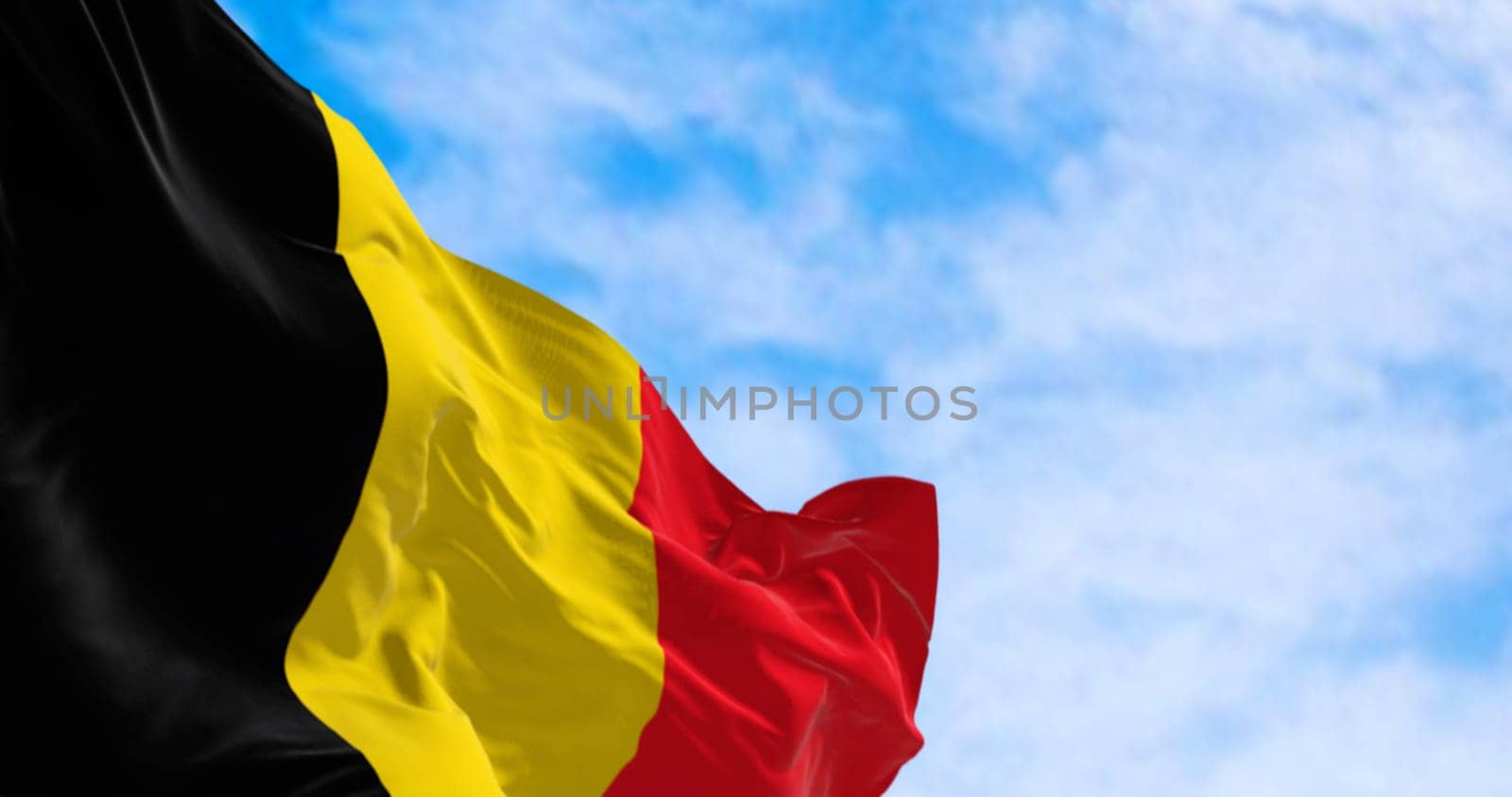 Close-up of the national flag of Belgium waving on a clear day. Three equal vertical bands: black, yellow and red. 3d illustration render. European country. Rippled fabric.