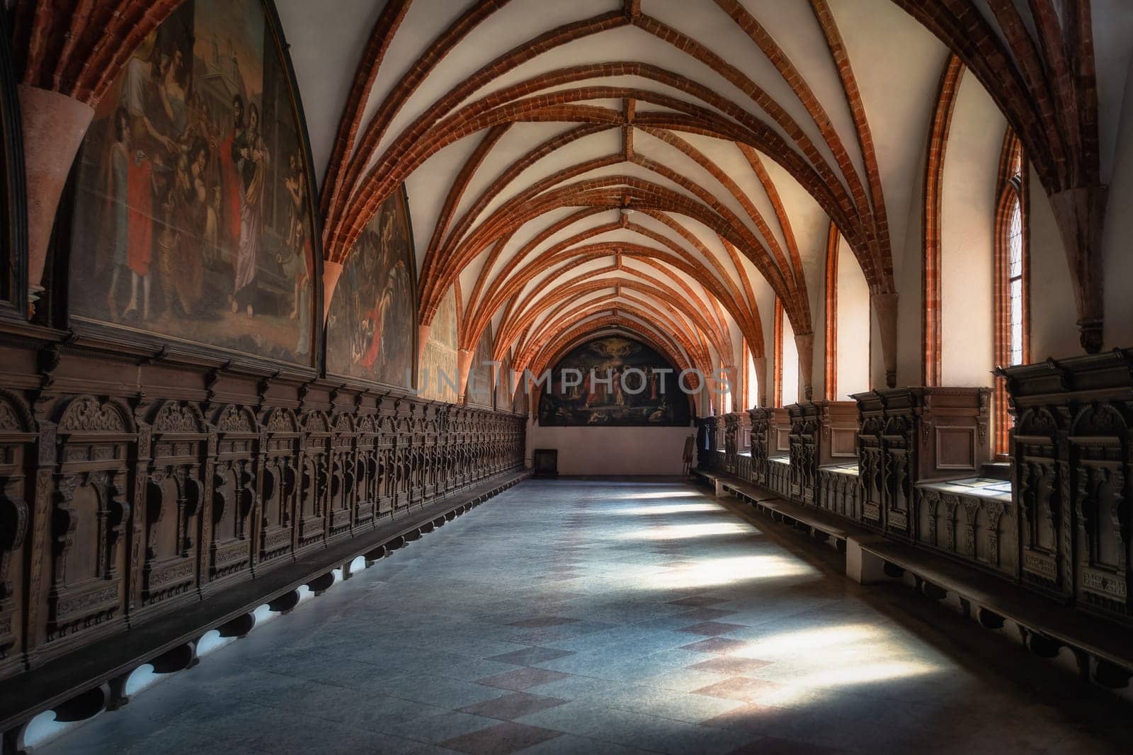 Side corridor with arches and beautiful decorations in Church of the Assumption of the Blessed Virgin Mary, Cathedral Basilica in Pelplin, Poland