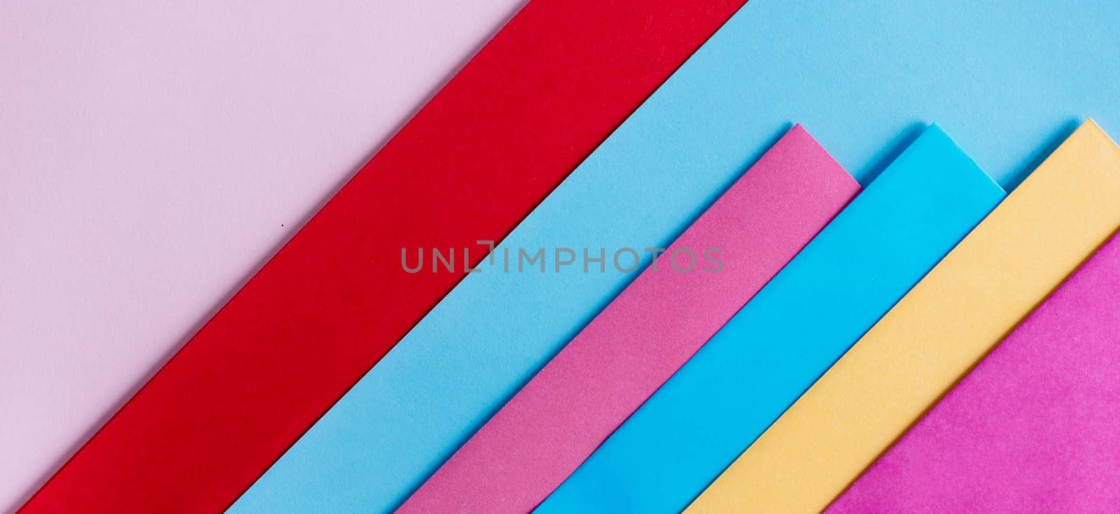 Trendy pastel colors in geometry shape flat lay. Colorful rainbow paper creative linear background. Abstract minimal vivid art design.
