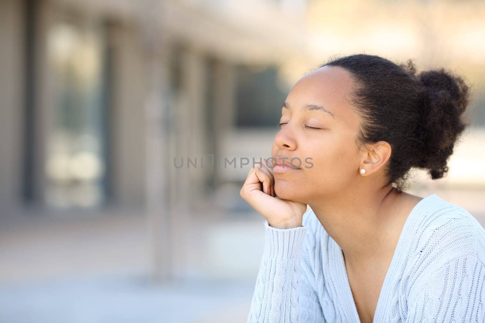 Black woman relaxing sitting in the street