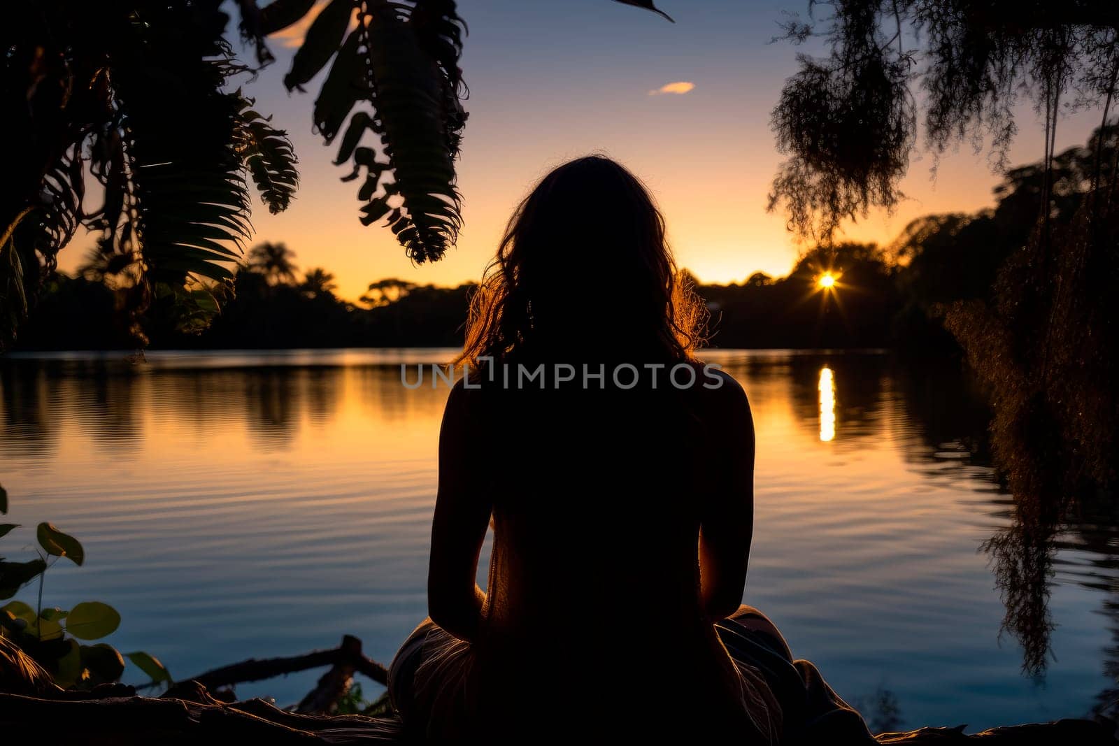Back view silhouette of a young woman sitting near a lagoon at night. Concepts of freedom, tranquillity.AI generated