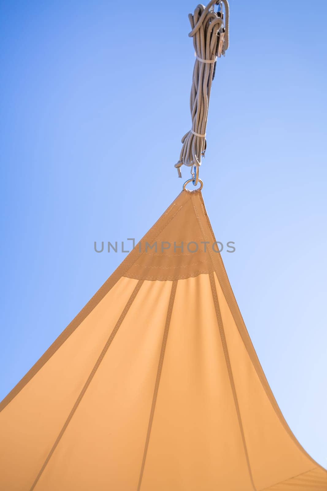 Detail of  sun shade sail or awnings against sunny blue sky for balcony or patio