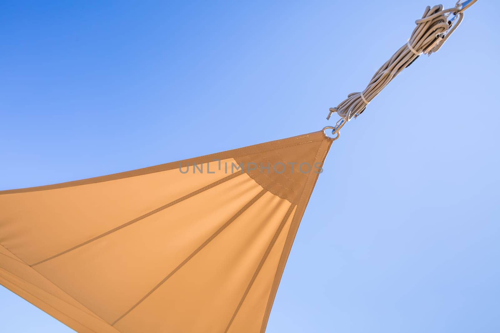Detail of  sun shade sail or awnings against sunny blue sky for balcony or patio