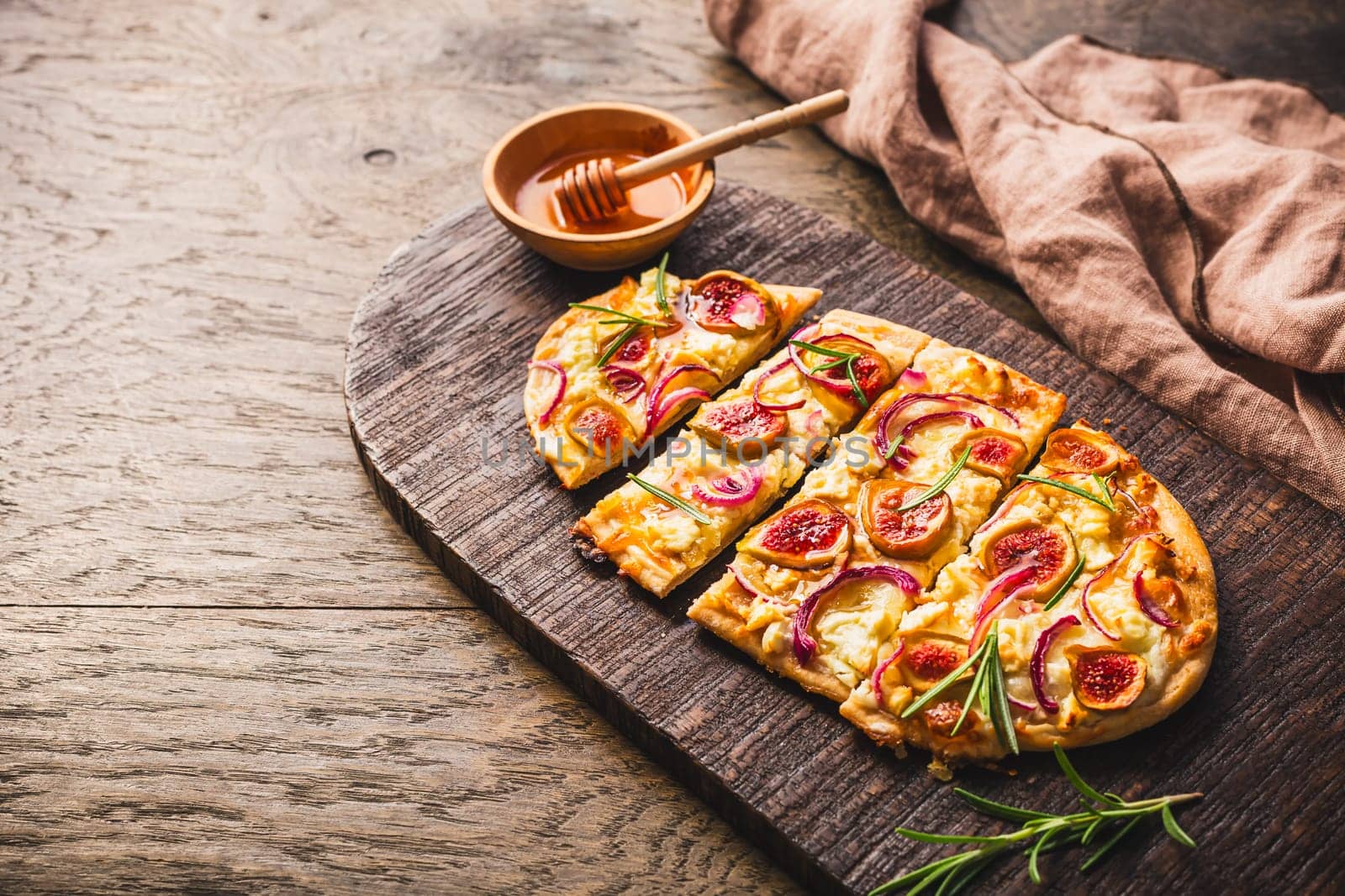 French Tarte Flambee (Flammkuchen) with figs, red onions, soft goat cheese and honey
