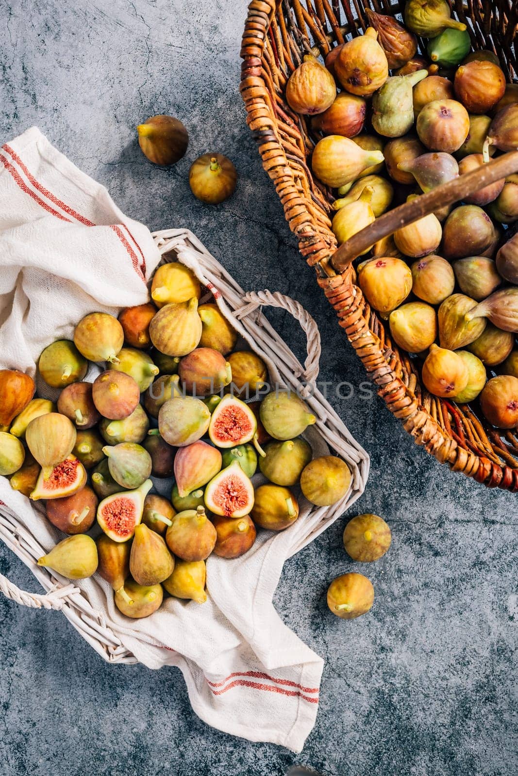 Freshly picked organic green figs in a basket on grey background