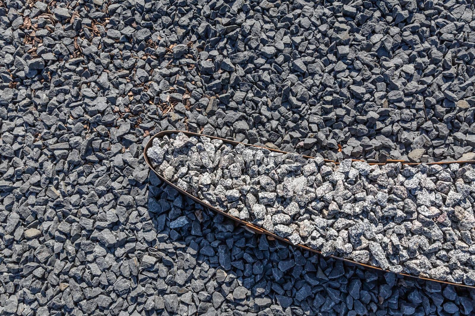 Dark gravel pebbles stone texture for modern garden design, stone garden