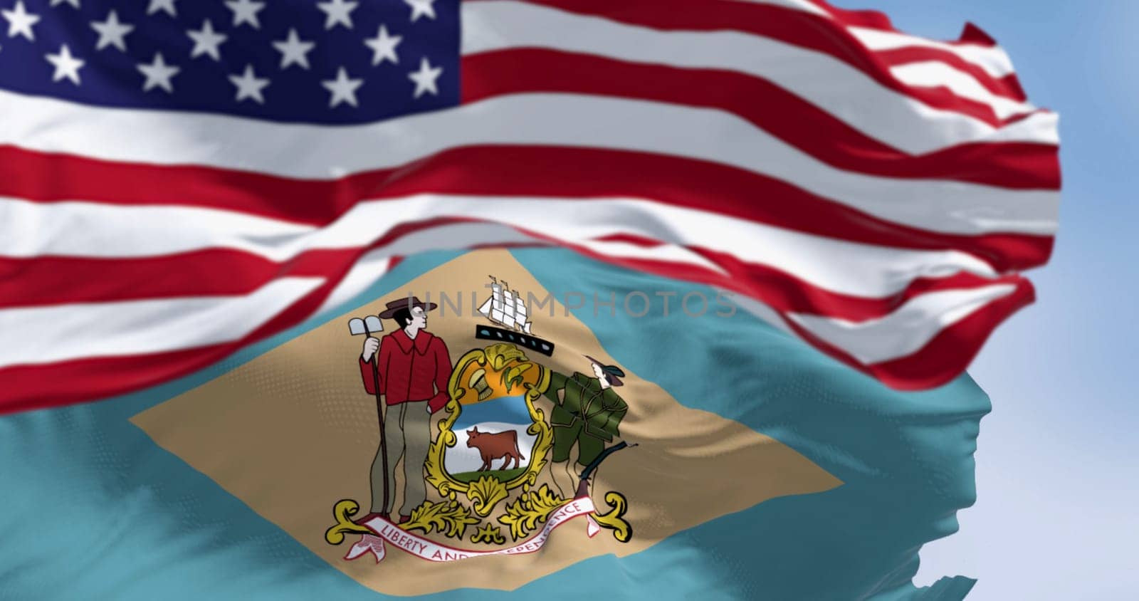 Delaware state flag waving with the national american flag. Yellowish-beige rhombus shape with the state coat of arms on a pale blue background. 3d illustration render. Selective focus