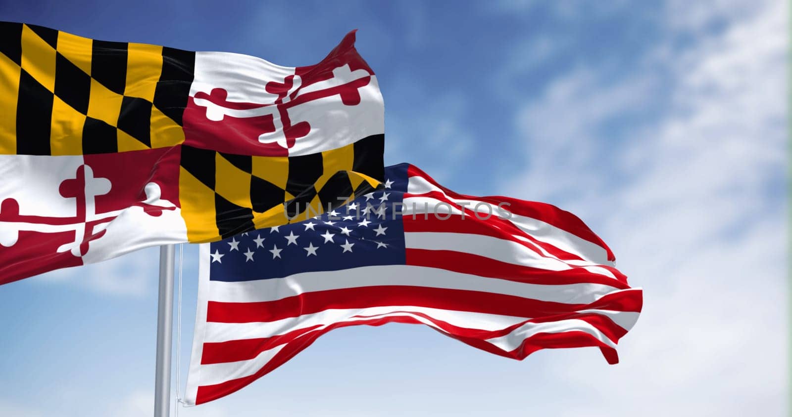 Maryland state flag waving in the wind with the american national flag on a clear day. 3d illustration render. Rippled fabric