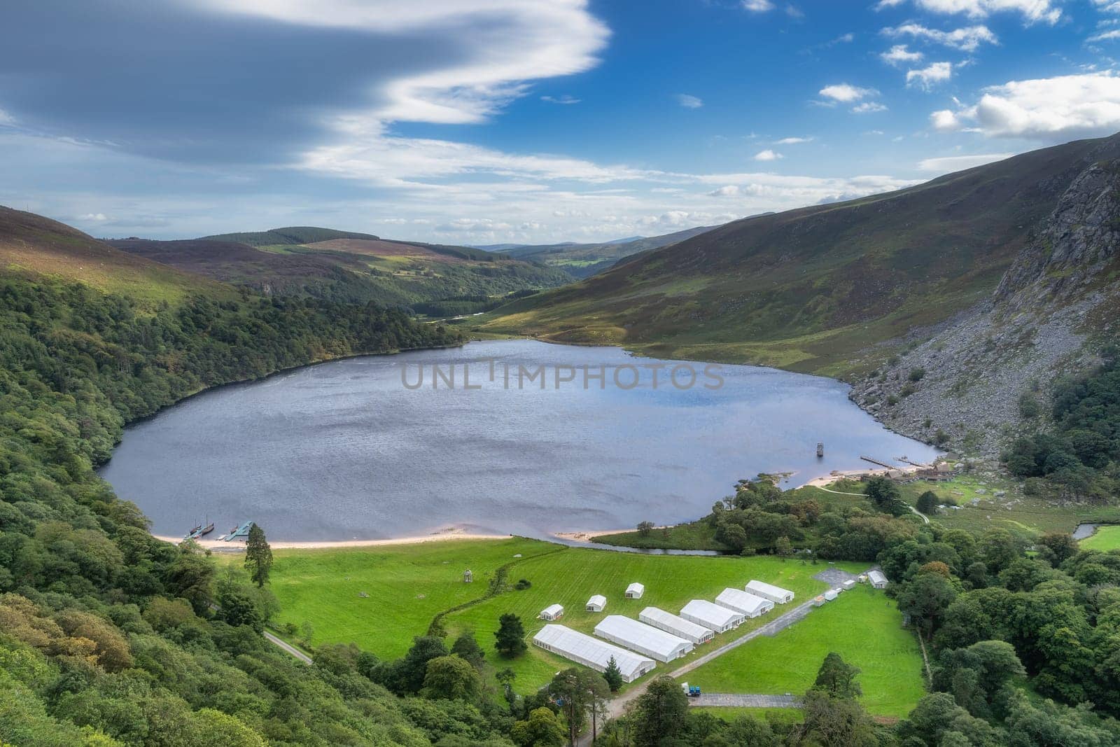 Aeril view on Lough Tay, called Guiness Lake with a TV show or movie set related to Viking era with longships and village, Wicklow Mountains, Ireland