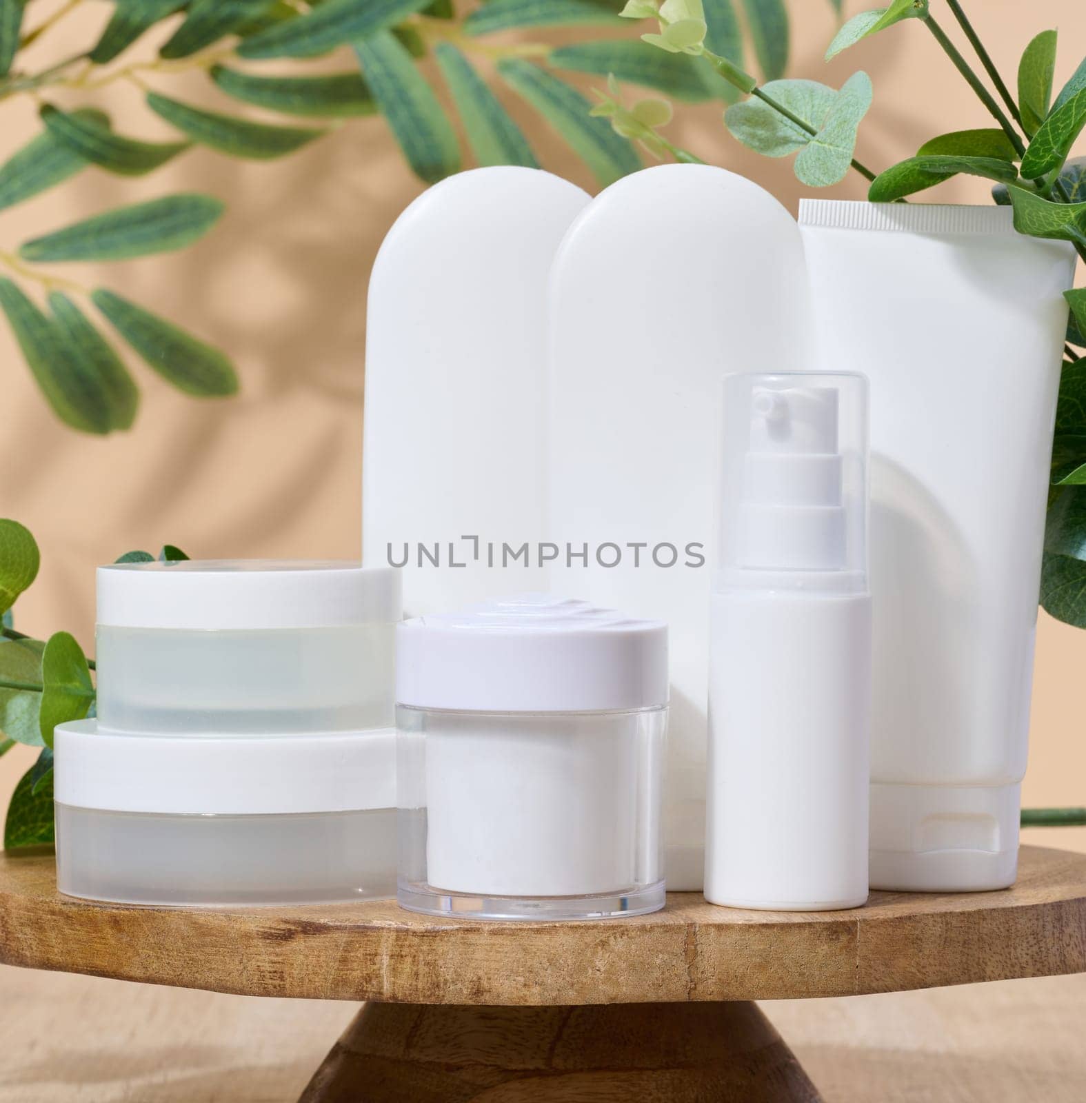 White plastic tubes and jar for cosmetic products on a white background, advertising and branding of products