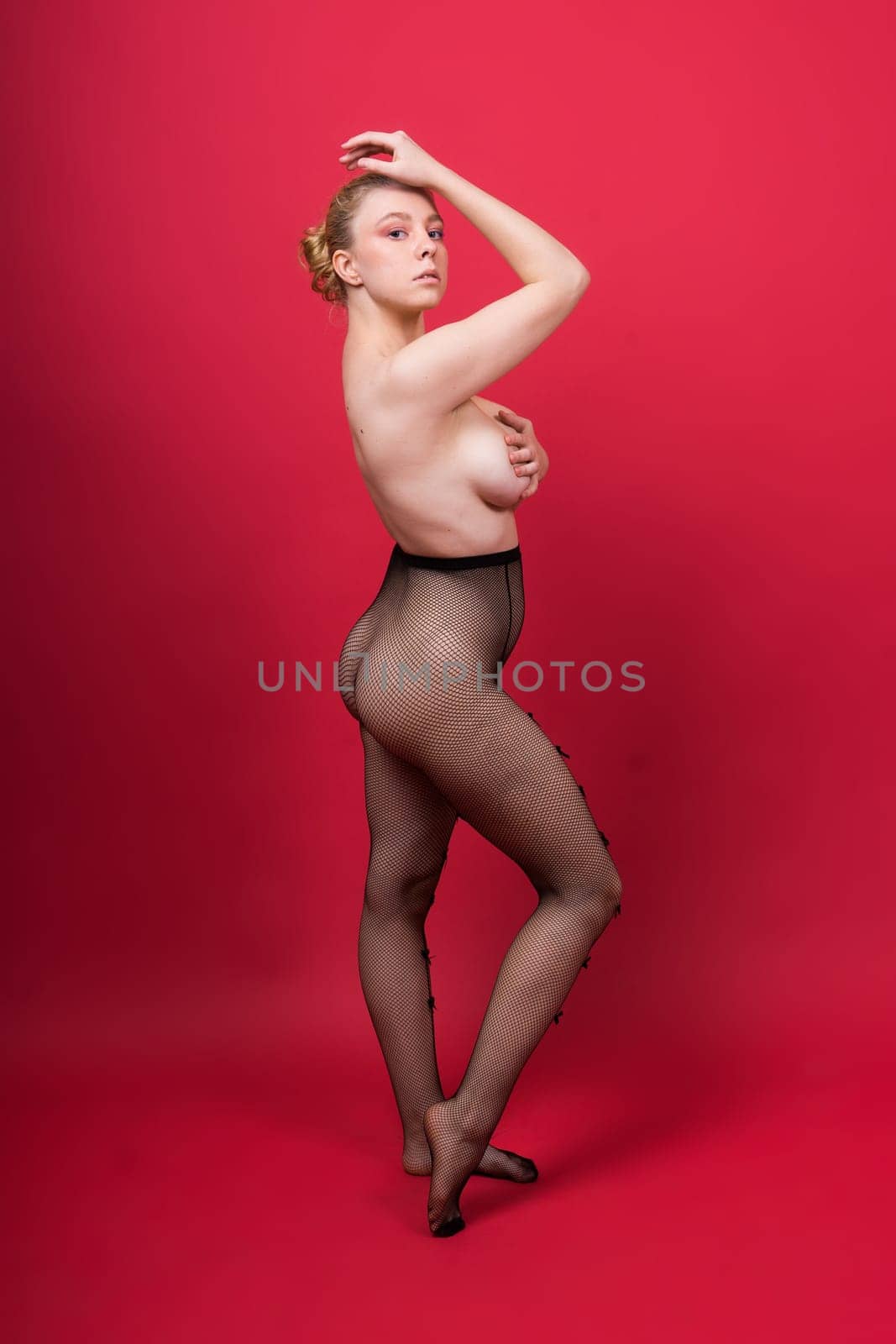 Young beautiful seductive woman with a large breasts. Carefree model wearing lingerie.