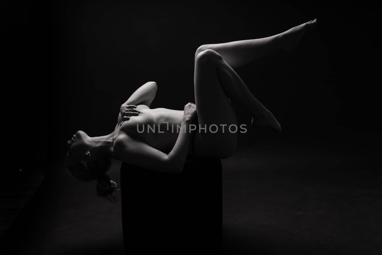 Photo of a gentle seductive topless plump lady isolated on black background