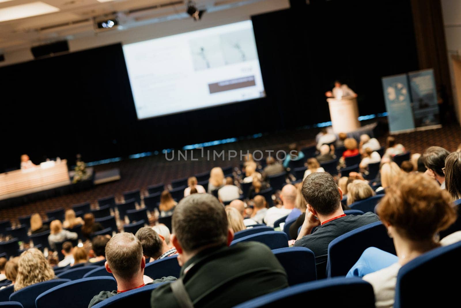 Speaker giving a talk on scientific conference. Audience at the conference hall. Business and Entrepreneurship concept