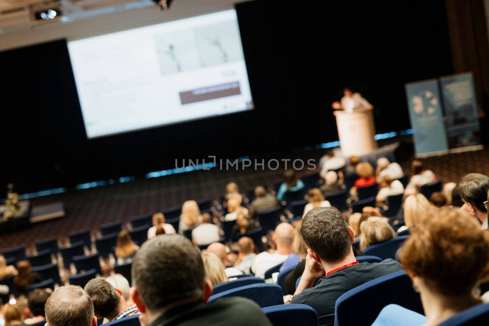 Speaker giving a talk on scientific conference. Audience at the conference hall. Business and Entrepreneurship concept