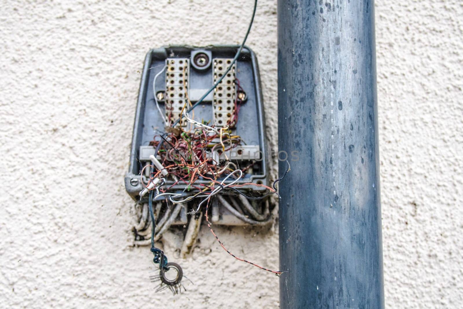 Destroyed wall distrubitor for analog Telephone Cable on a house facade