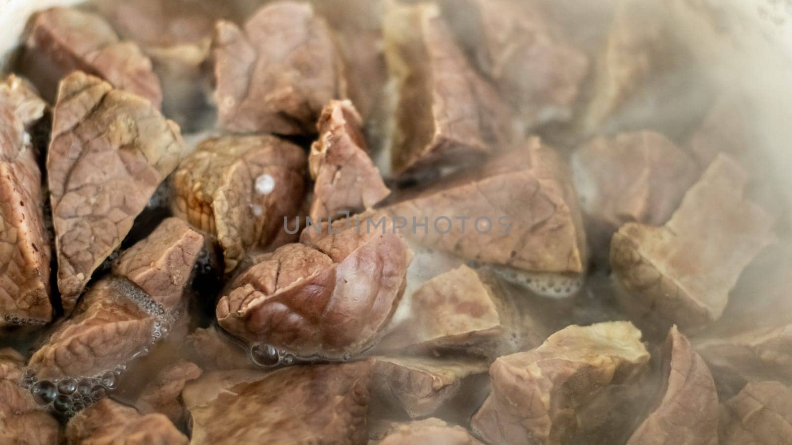 Pork lung in boiled hot water. Close-up of the preparation of a Thai dish. Boiled bovine or beef lungs, pork entrails
