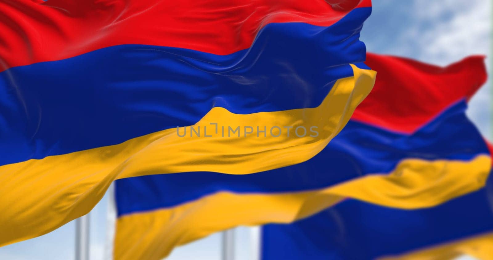 Three Armenia national flags waving in the wind. Three horizontal bands in red, blue and apricot. 3d illustration render. Rippled fabric. Selective focus