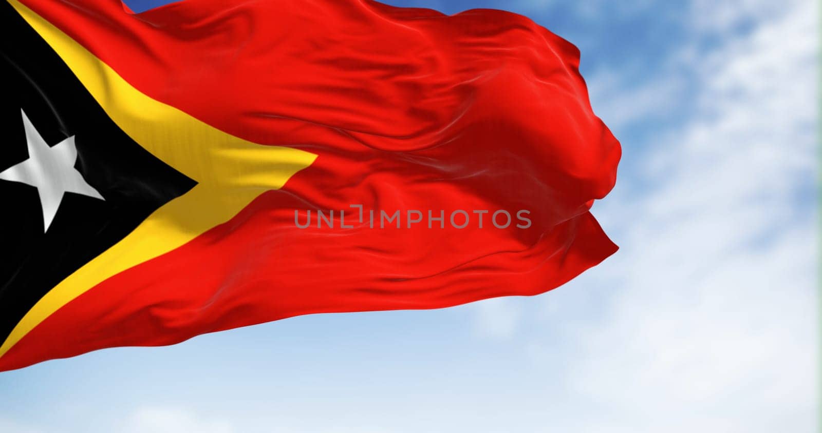 National flag of East Timor waving in the wind on a clear day. 3d illustration render. Rippled fabric