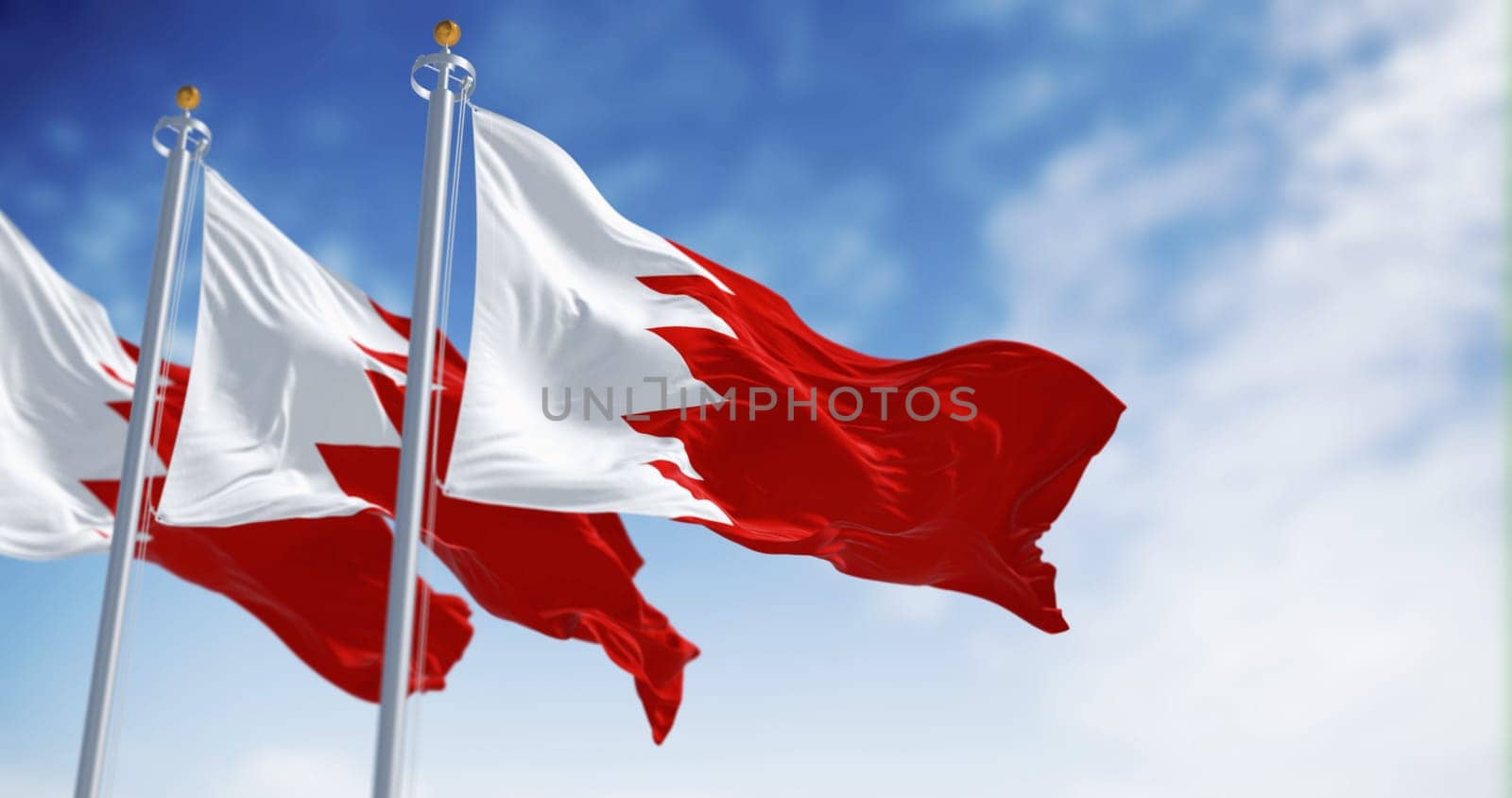 Three Bahrain flags waving on a clear day. White band on the left and a red area on the right, separated by five triangles forming a serrated line. 3d illustration render. Fluttering fabric