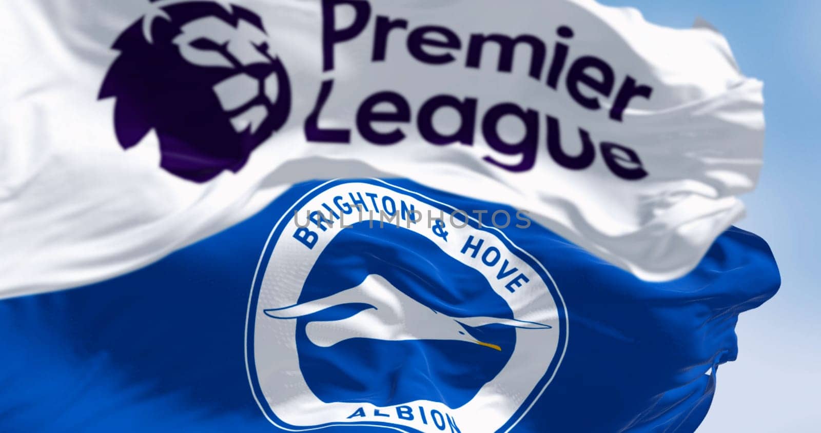 Brighton, UK, Aug. 23 2023: Brighton football club and Premier League flags waving in the wind on a clear day. Illustrative editorial 3d illustration render. Selective focus. Rippled fabric