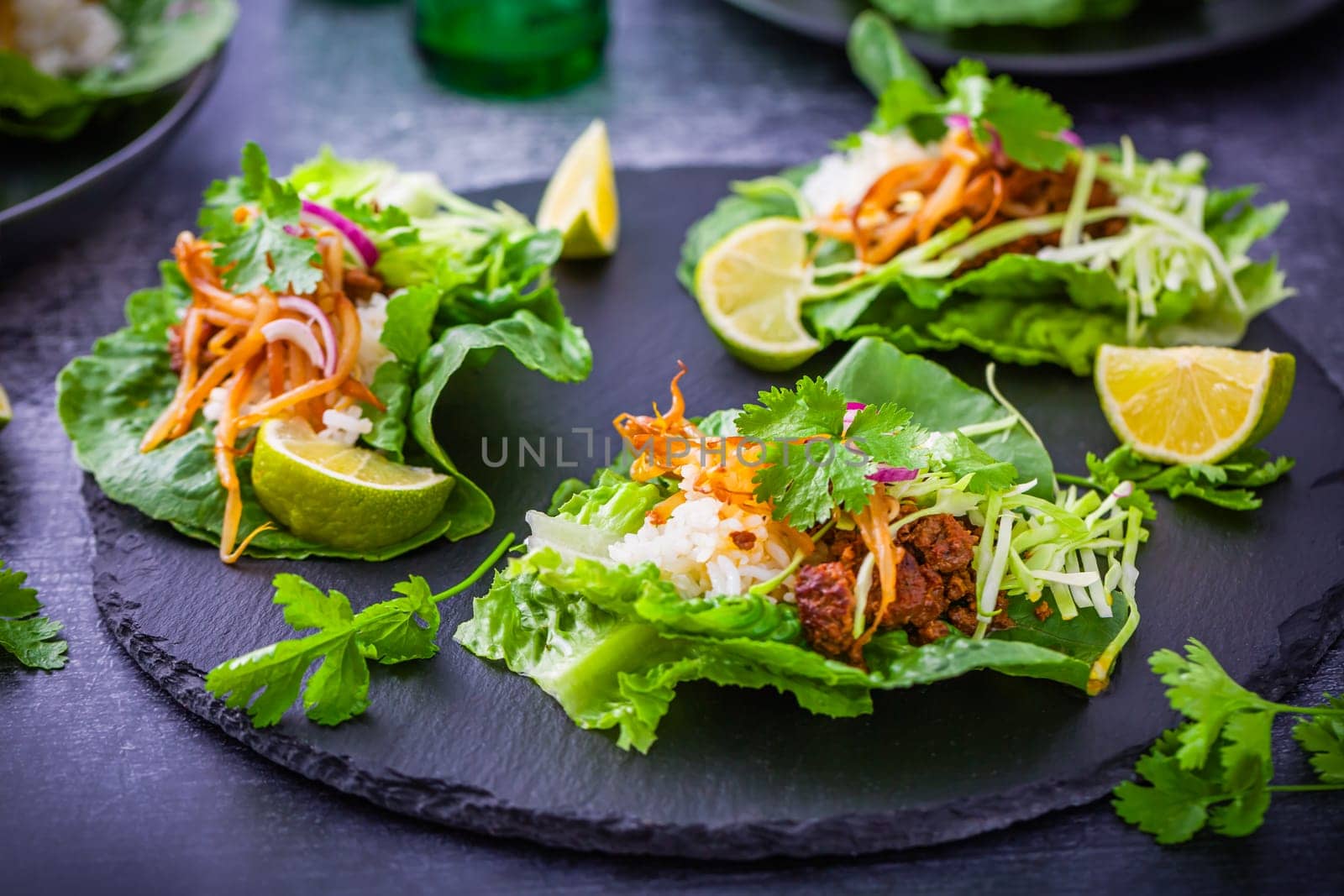Asian minced meat lettuce wraps with rice, bean sprouts and cabbage