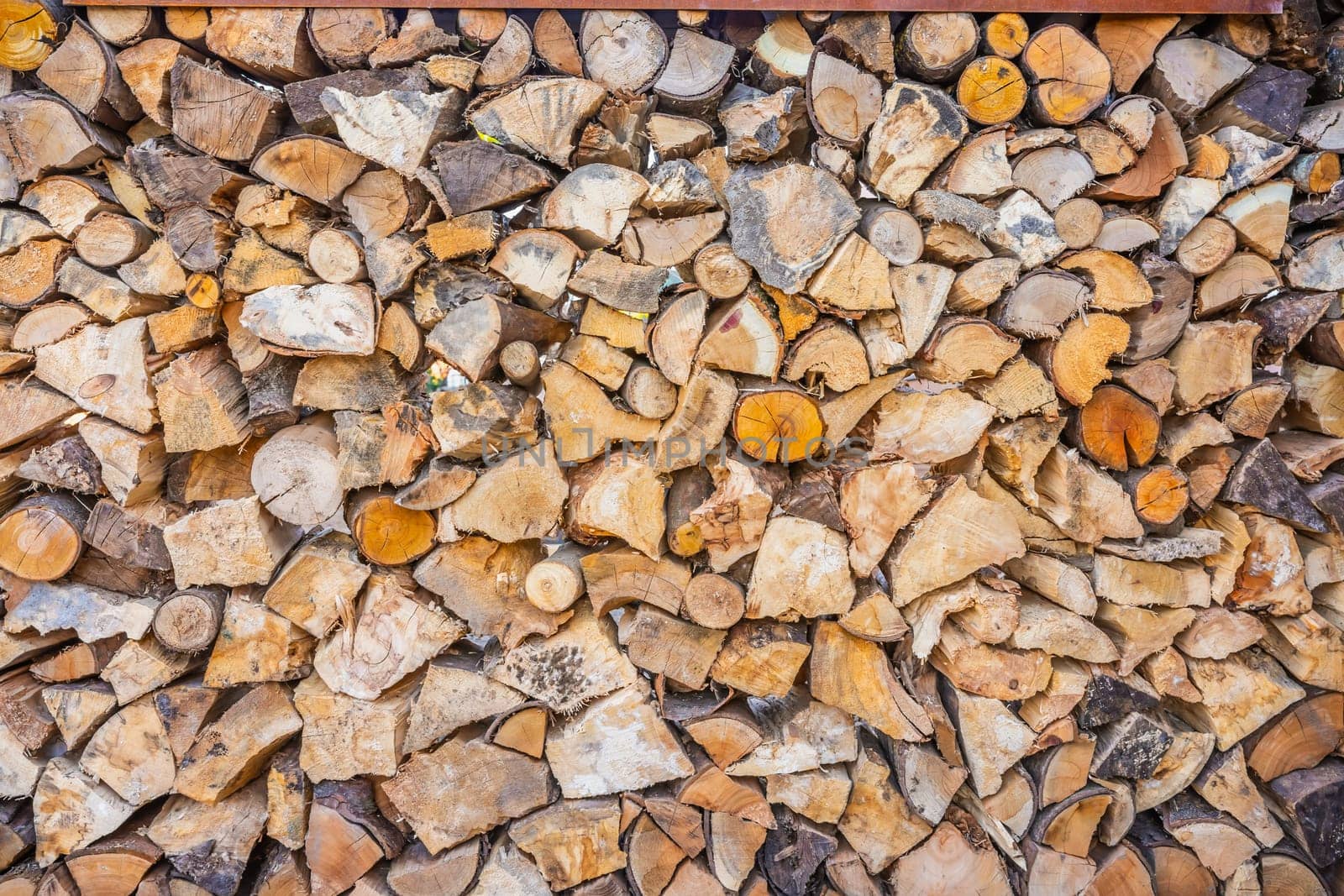 Close up of logs stored to dry for use in a log burner, firewood