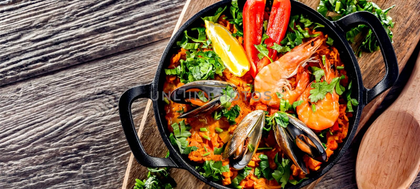 Seafood paella served in a cast iron pan.
