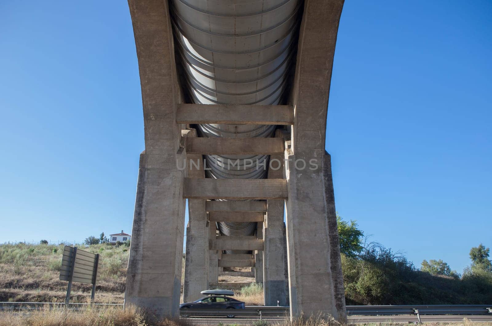 Vehicule crossing under Acedera Aqueduct through N430 National Road. Motion blurred