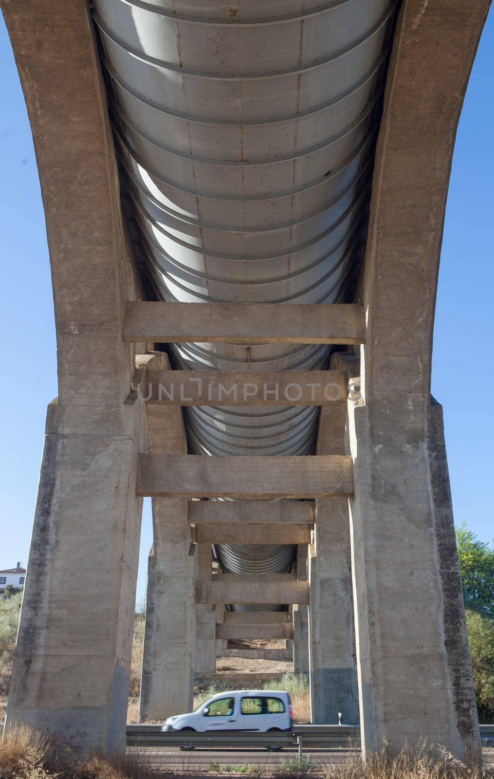 Vehicule crossing under Acedera Aqueduct through N430 National Road. Motion blurred