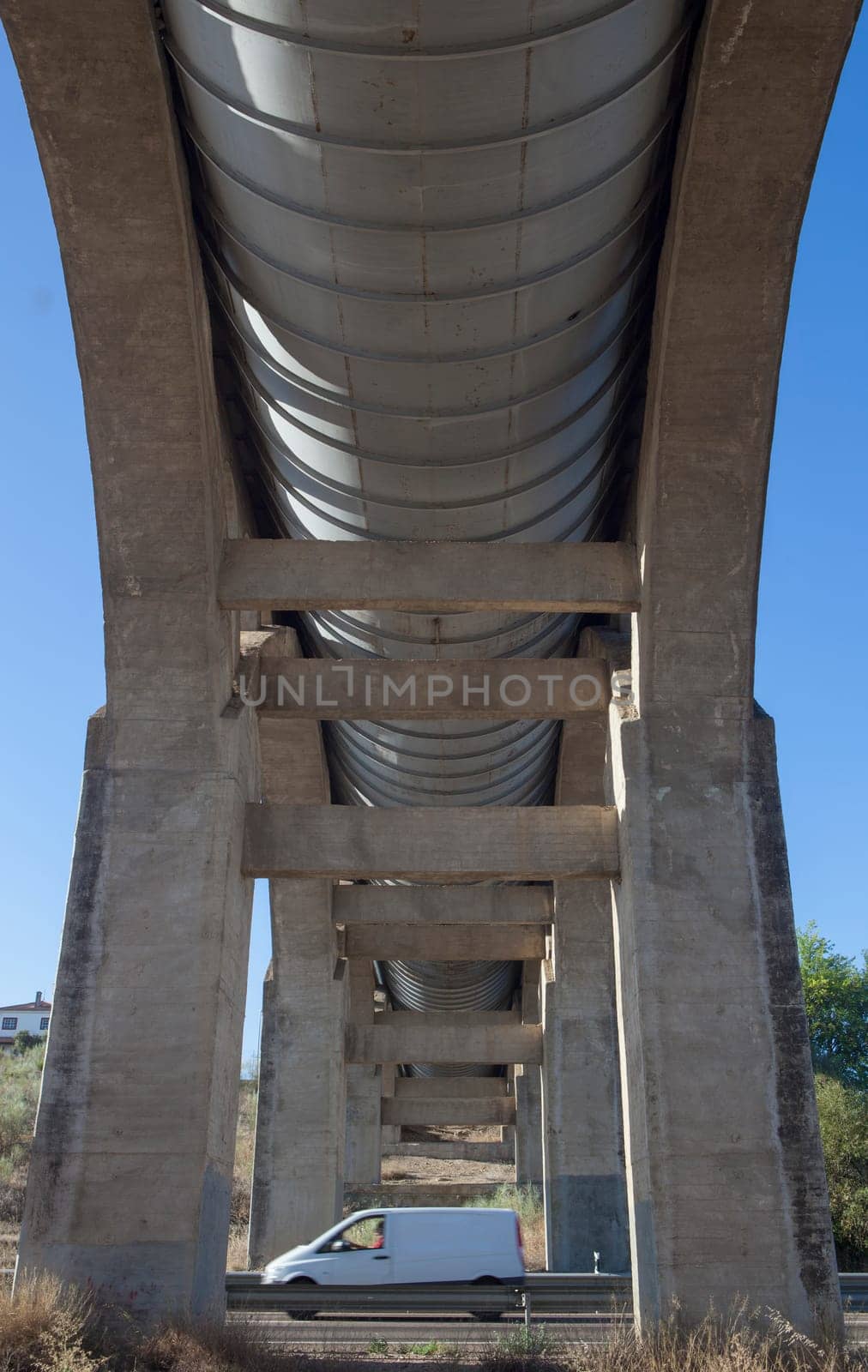 Vehicule crossing under Acedera Aqueduct through N430 National Road. Motion blurred