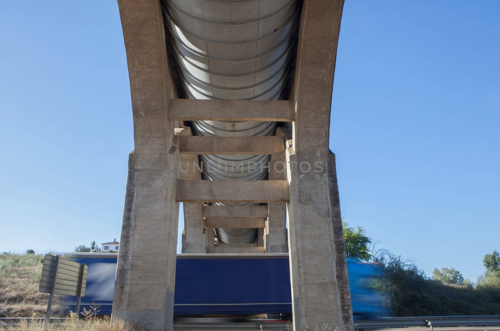 Truck crossing under Acedera Aqueduct through N430 National Road. Motion bluerred