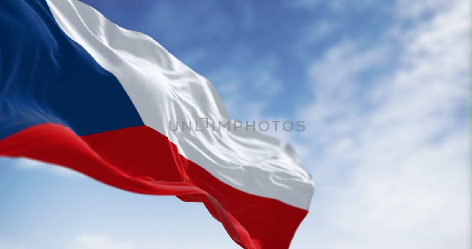 National flag of Czech Republic waving in the wind on a clear day. Two equal horizontal bands of white and red with a blue isosceles triangle on the hoist side. 3d illustration render. Rippled fabric