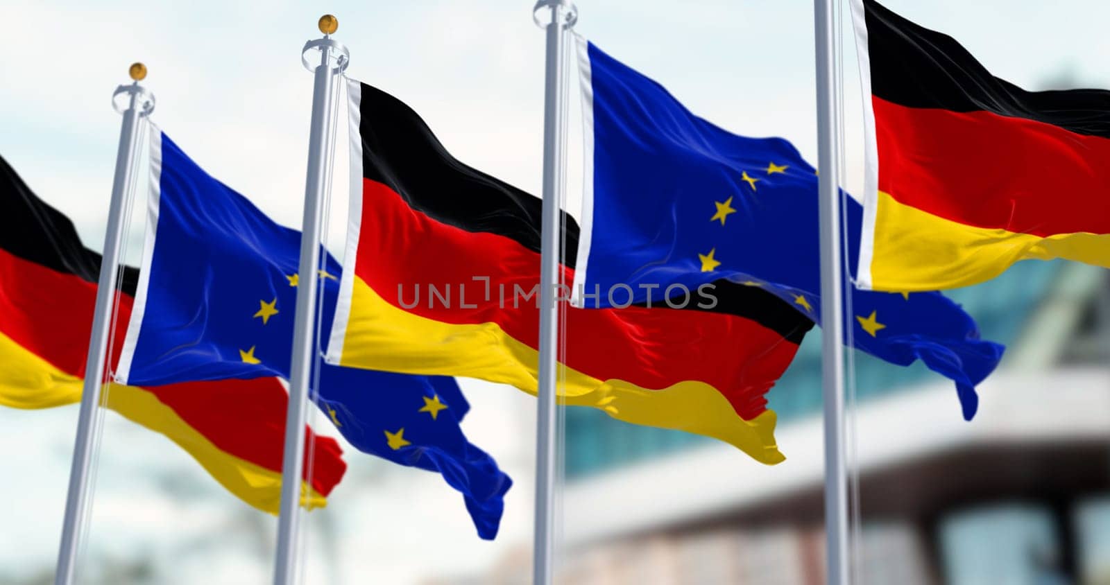 Flags of Germany and the European Union waving in the wind on a clear day. Germany became a member of the EU in january 1958. 3d illustration render. Fluttering fabric