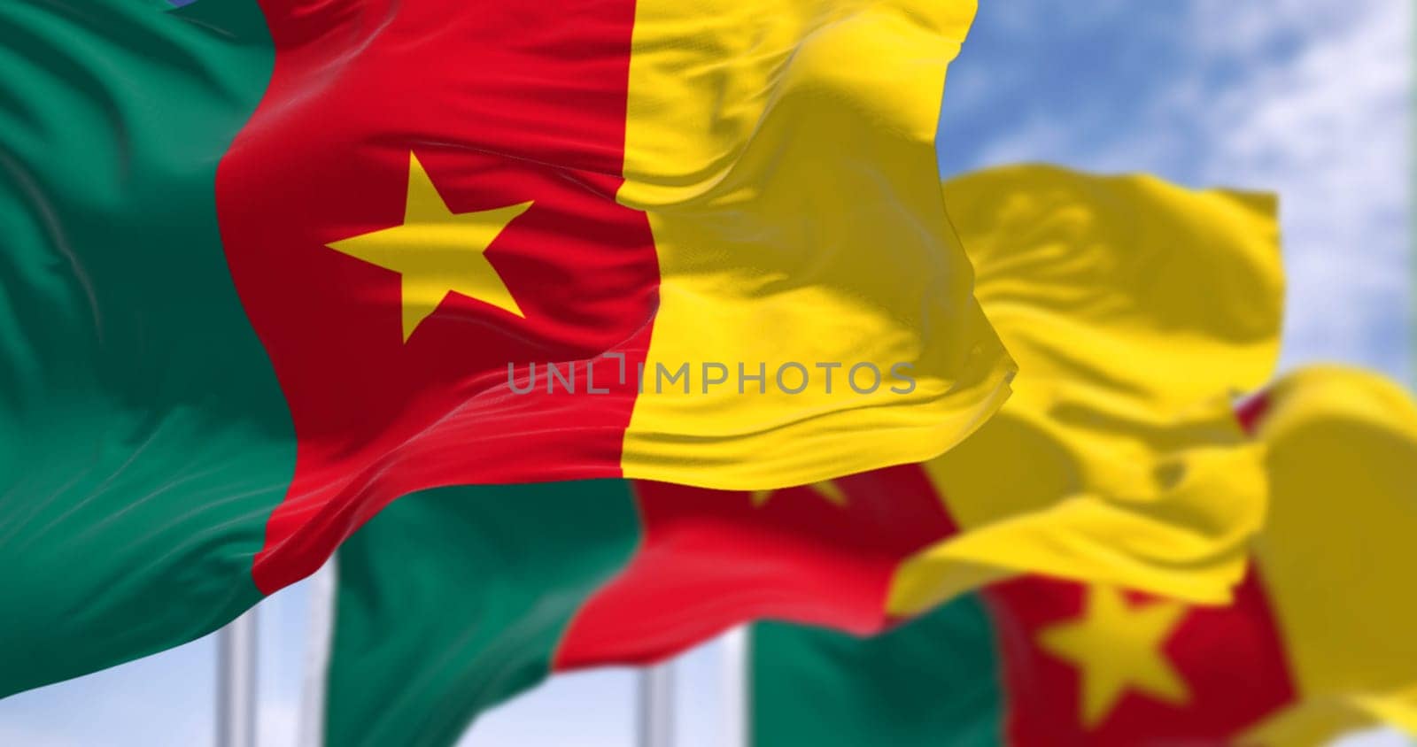 Three Cameroon national flags waving in the wind. Three vertical stripes of green, red, and yellow, yellow star in the center. 3d illustration render. Fluttering fabric. Selective focus